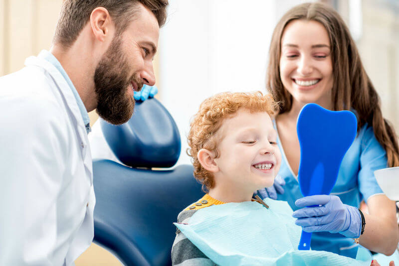 kid smiling at dentist