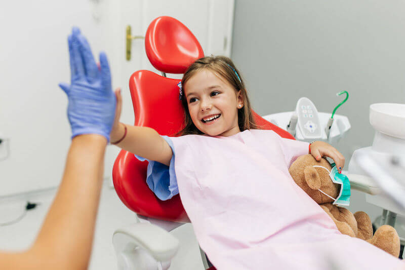 Kid High-Fiving Dentist - Dentistry For Children